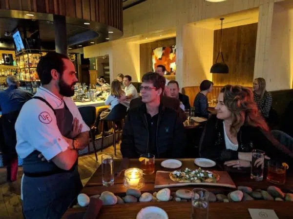 Chef Chris Sarkus talking with Denver food tour guests in Urban Farmer Denver