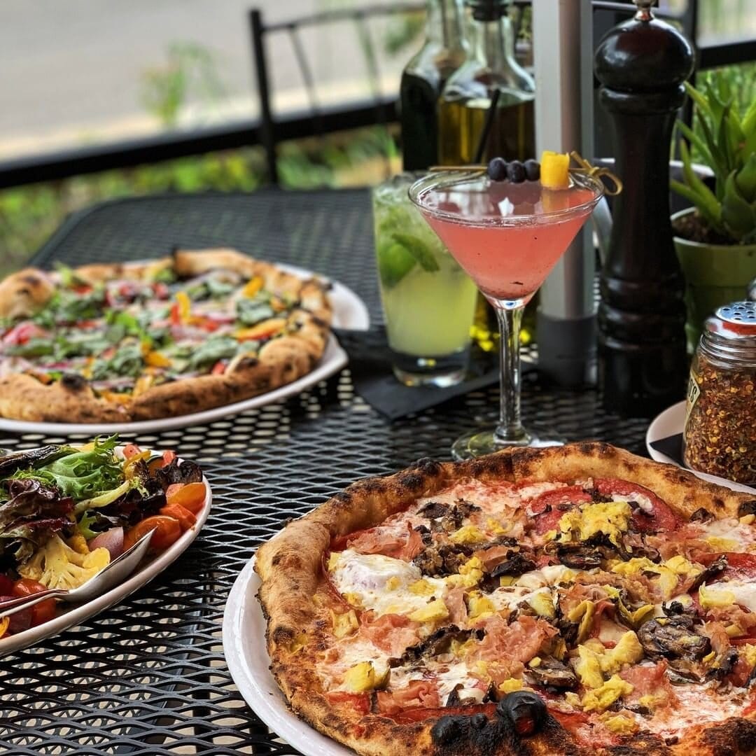 Enjoy authentic Neapolitian pizza with a cocktail on the patio