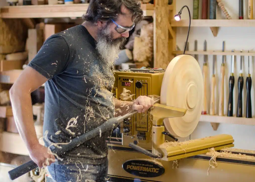 A man sanding wood at the Denver Tool Library