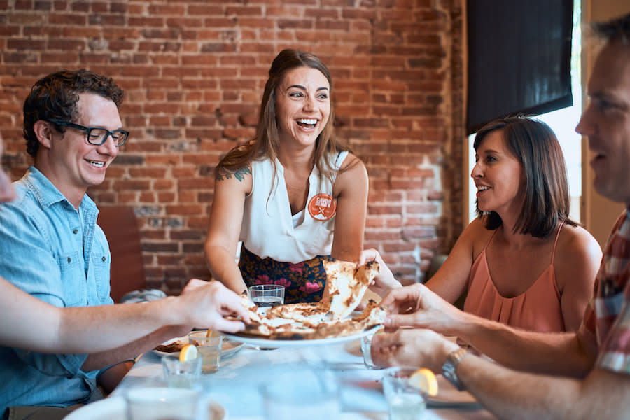 A smiling group of people on a Delicious Denver Food Tour.