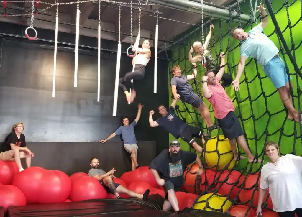 A group experiencing the obstacles at Warrior Challenge Arena