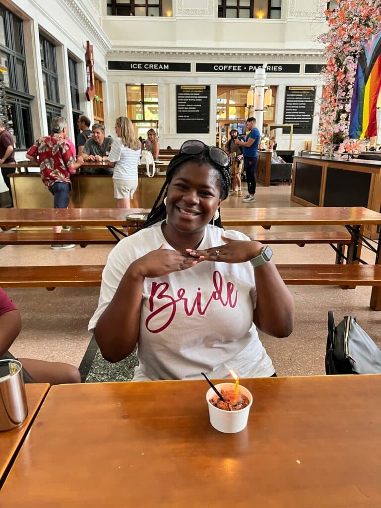 A woman posed in Denver Union Station while attending a Delicious Denver Food Tour