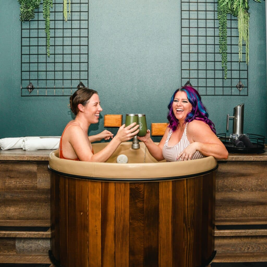 Two women soaking at the unique Beer Spa in Denver