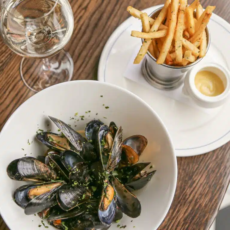 Steamed mussels, pomme friters, and a glass of white wine from Bistro LeRoux