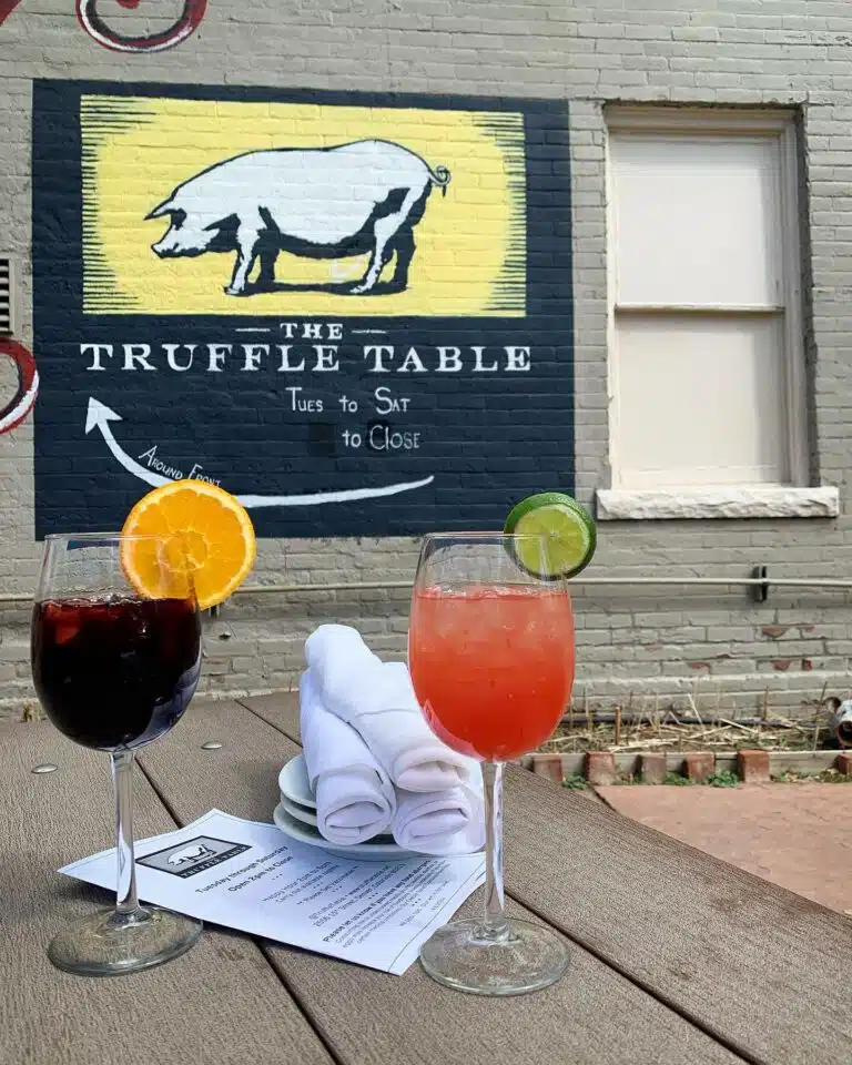 Two sangria glasses resting on an outdoor patio table at The Truffle Table in Denver