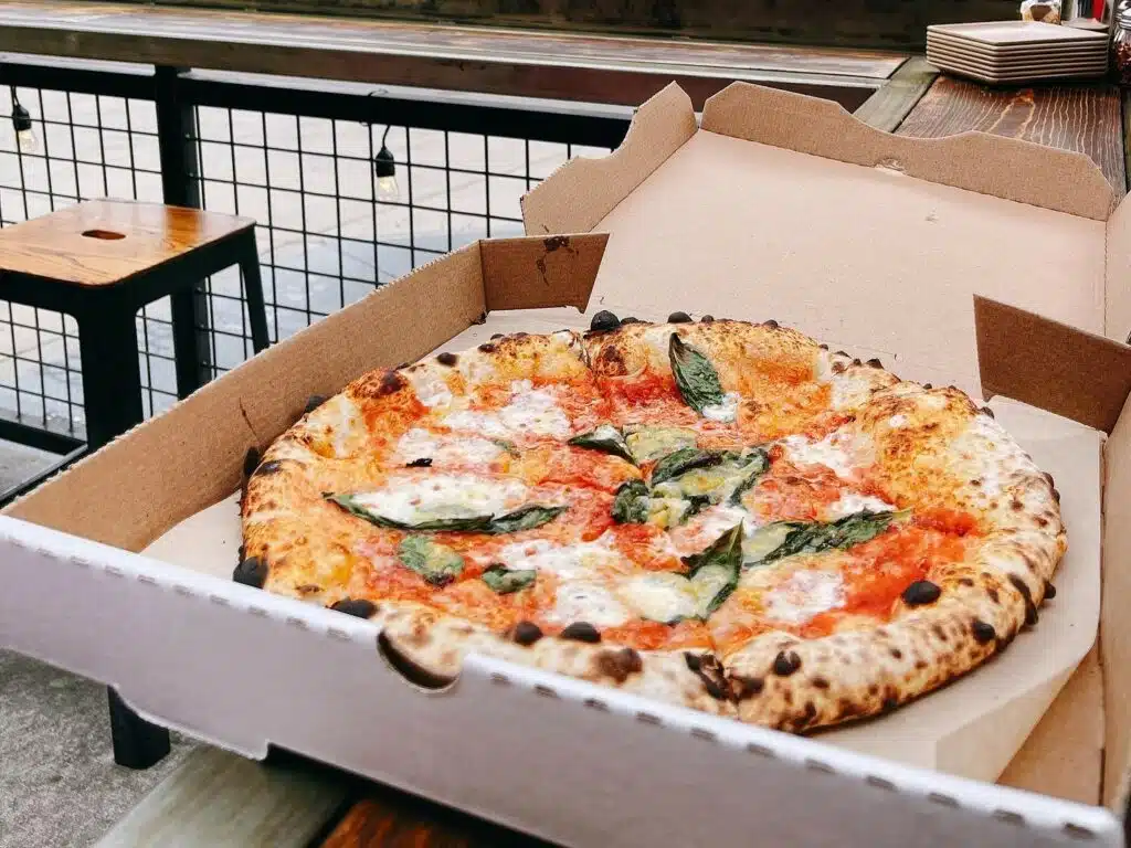 A box of pizza on the patio at Cart-Driver