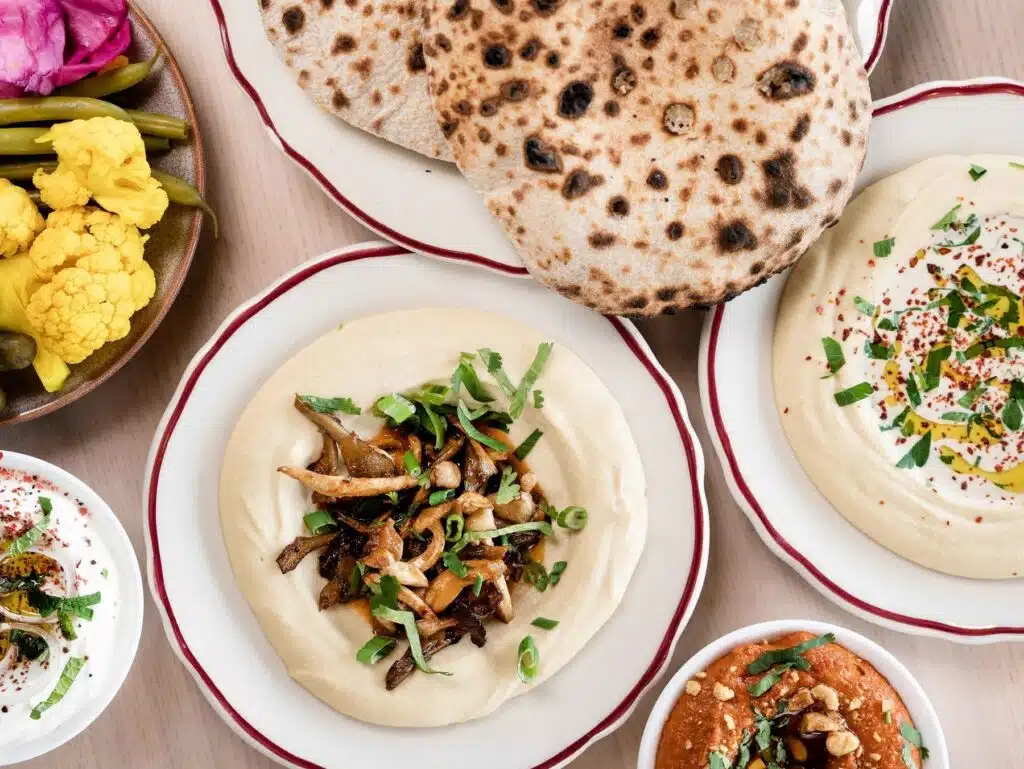 If you're not sure what to eat in RiNo, try the house-baked pita and an assortment of dips from Safta, pictured here