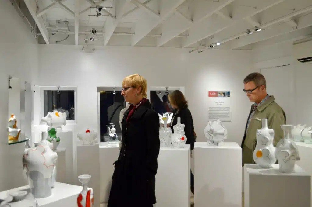 Guests admiring contemporary pottery at Plinth Gallery, one of many RiNo art galleries