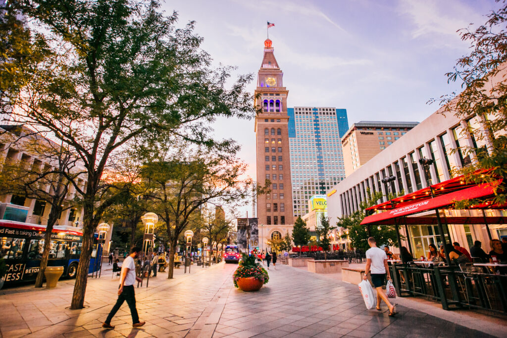 the street, cafes, pedestrians and the daniel fisher clocktower on the 16th street mall