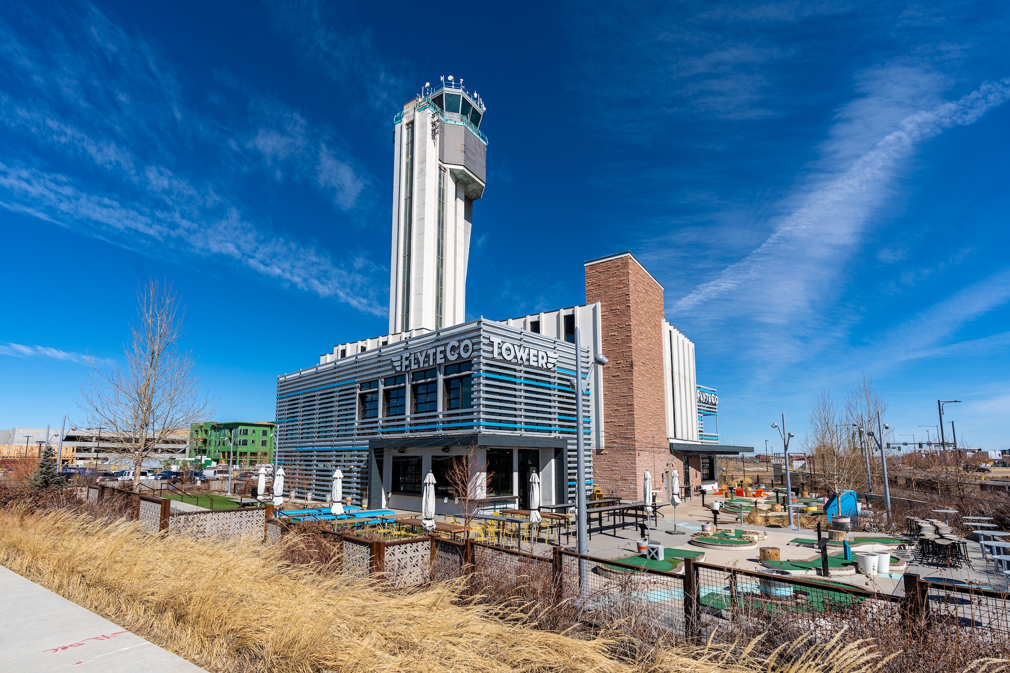The exterior of FlyteCo Tower, featuring a large patio and outdoor putt-putt 