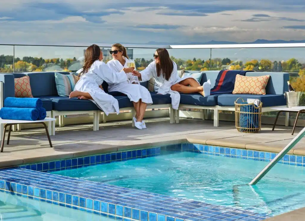 A group of women by the rooftop pool at the Halcyon Hotel Denver