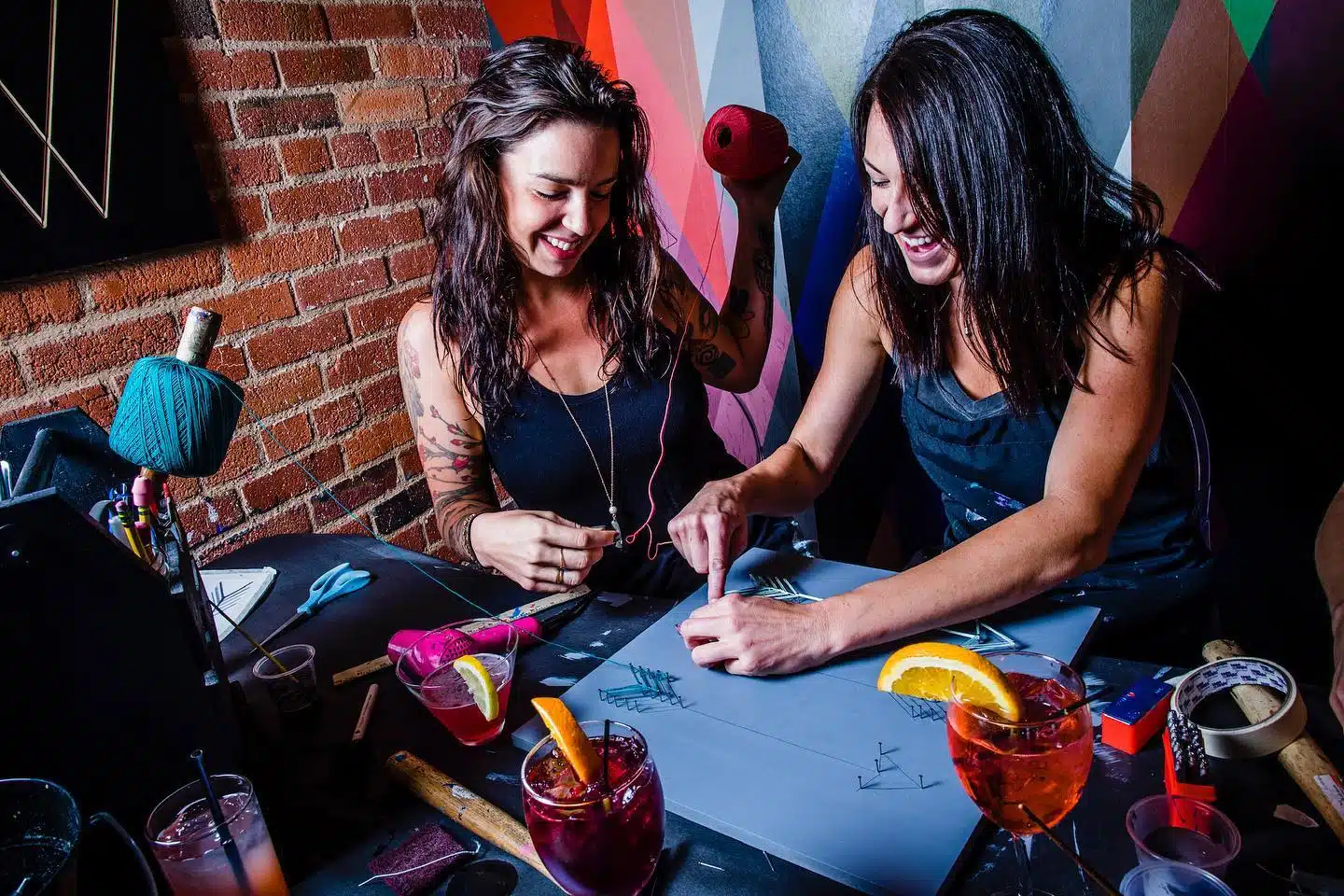 Two women working on a craft at Upstairs Circus