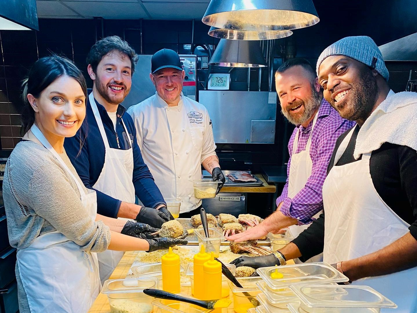 A corporate group at Cook Street School of Culinary Arts, one of the best team building activities in Denver
