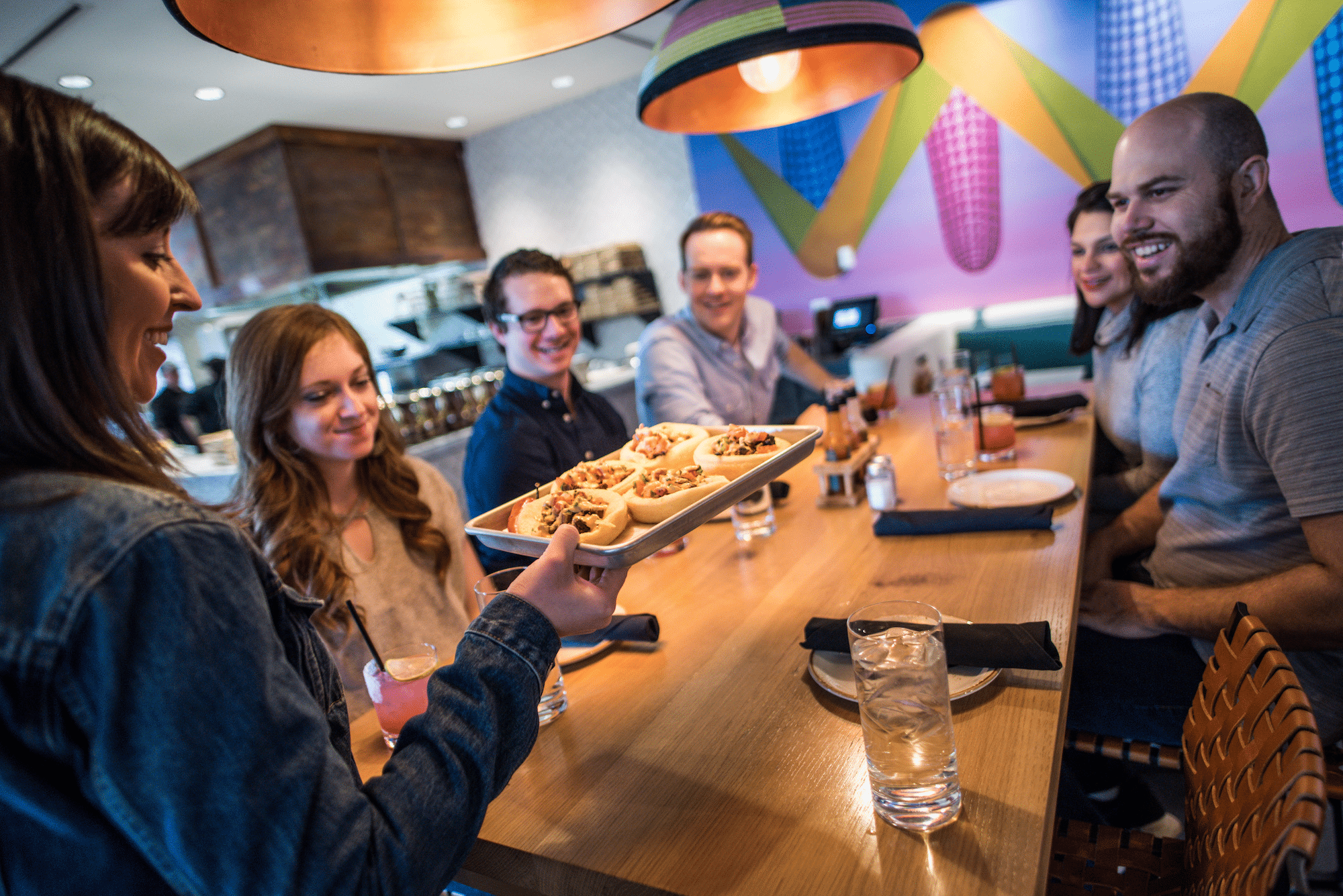 A corporate team on a food hall tour, one of the best team building dinner events in Denver