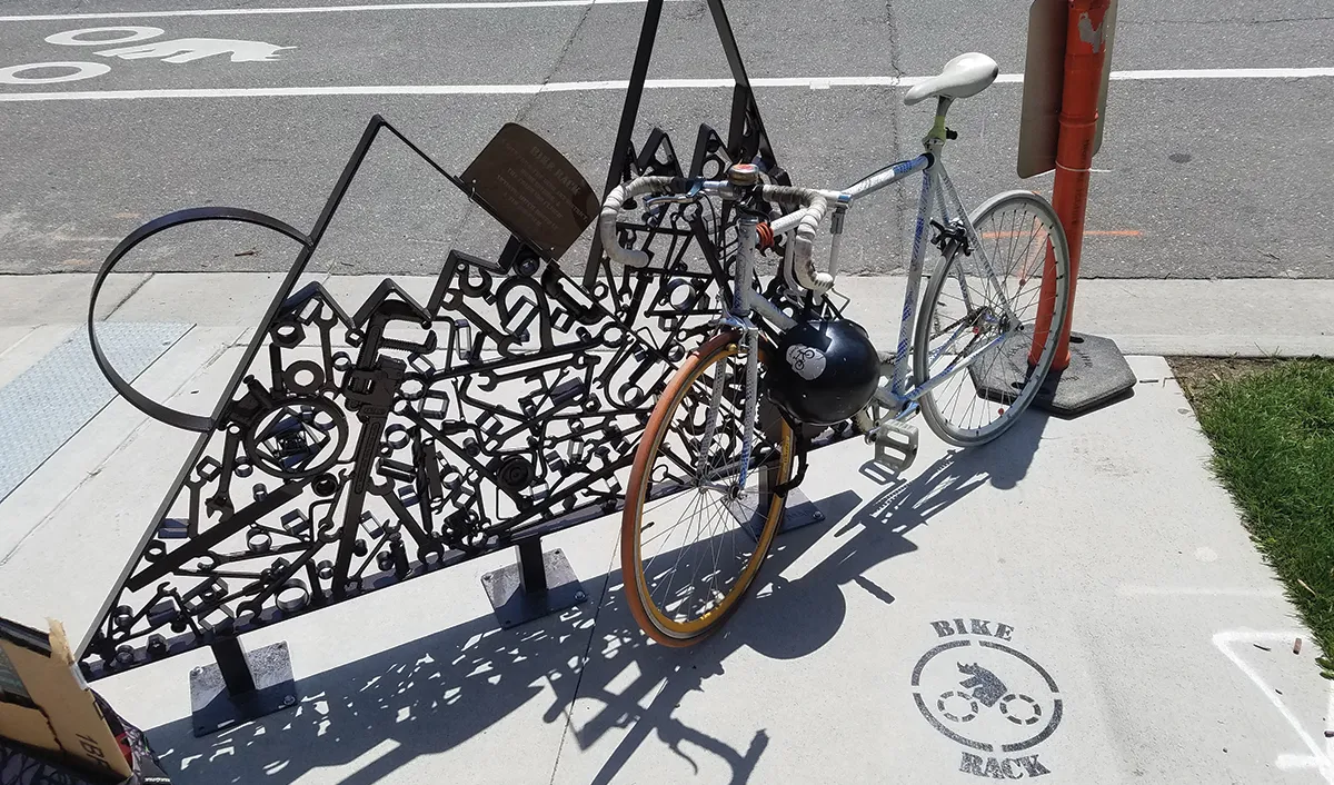 A bike locked to a mountain-shaped rack in RiNo