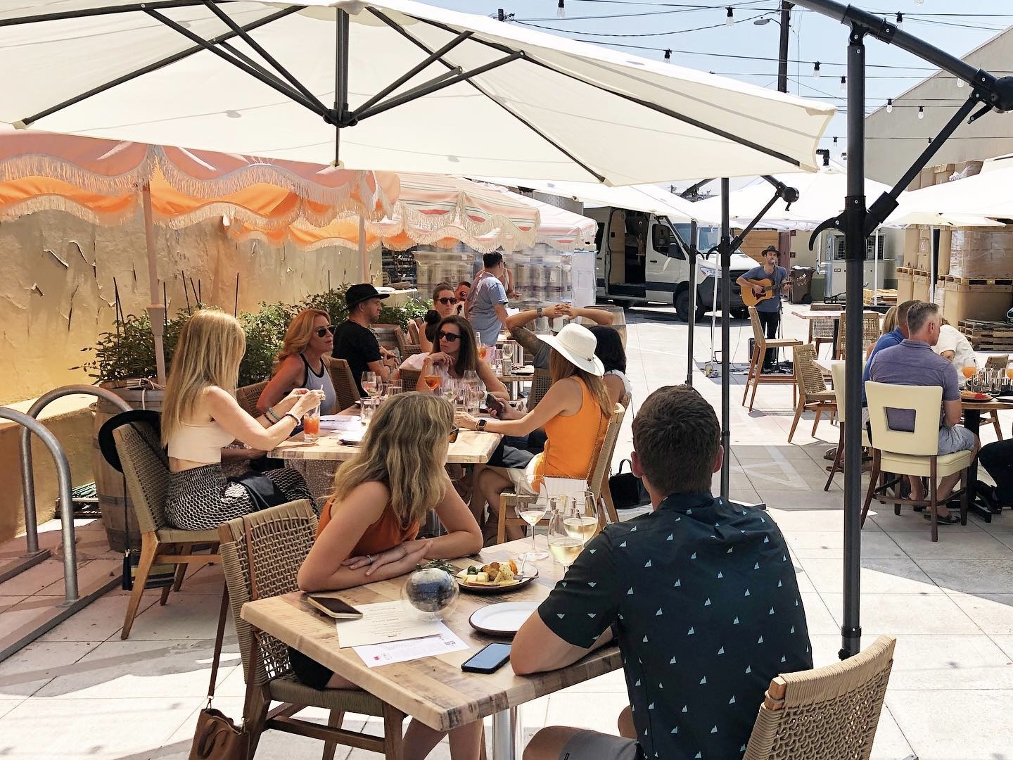 People seated at tables on Attimo Winery's patio