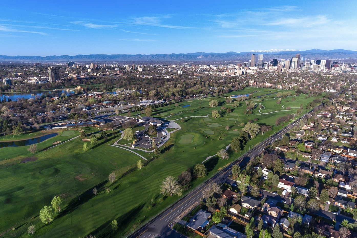 An aerial view of City Park Golf Course, backdropped by Denver and the mountains