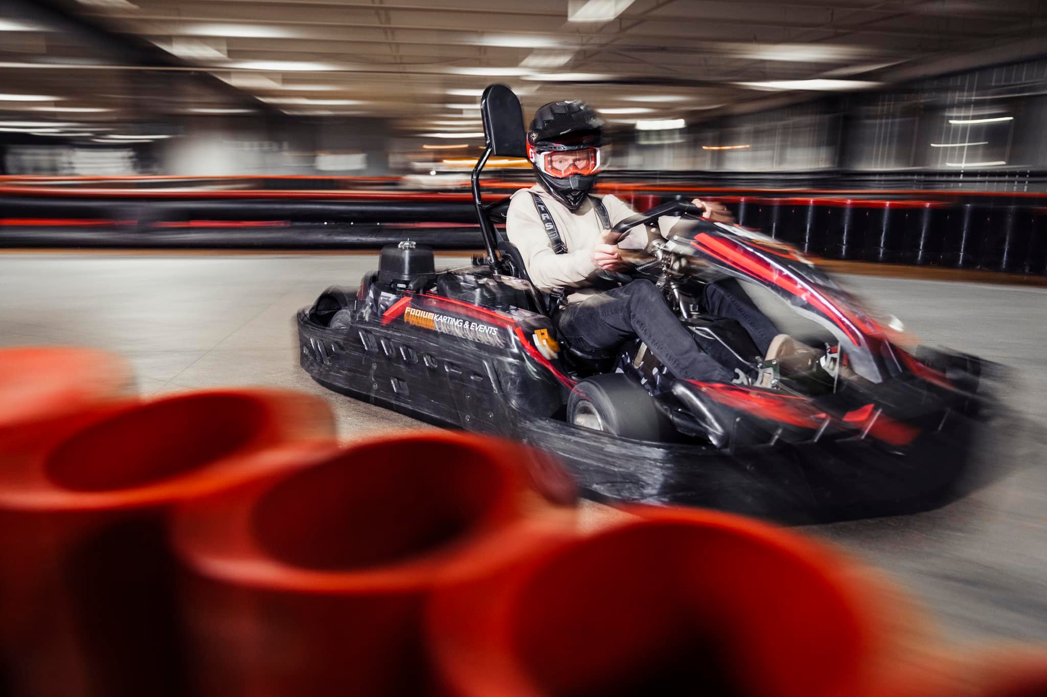 A man racing a go-kart at Podium Karting & Events, one of the best team outing ideas 