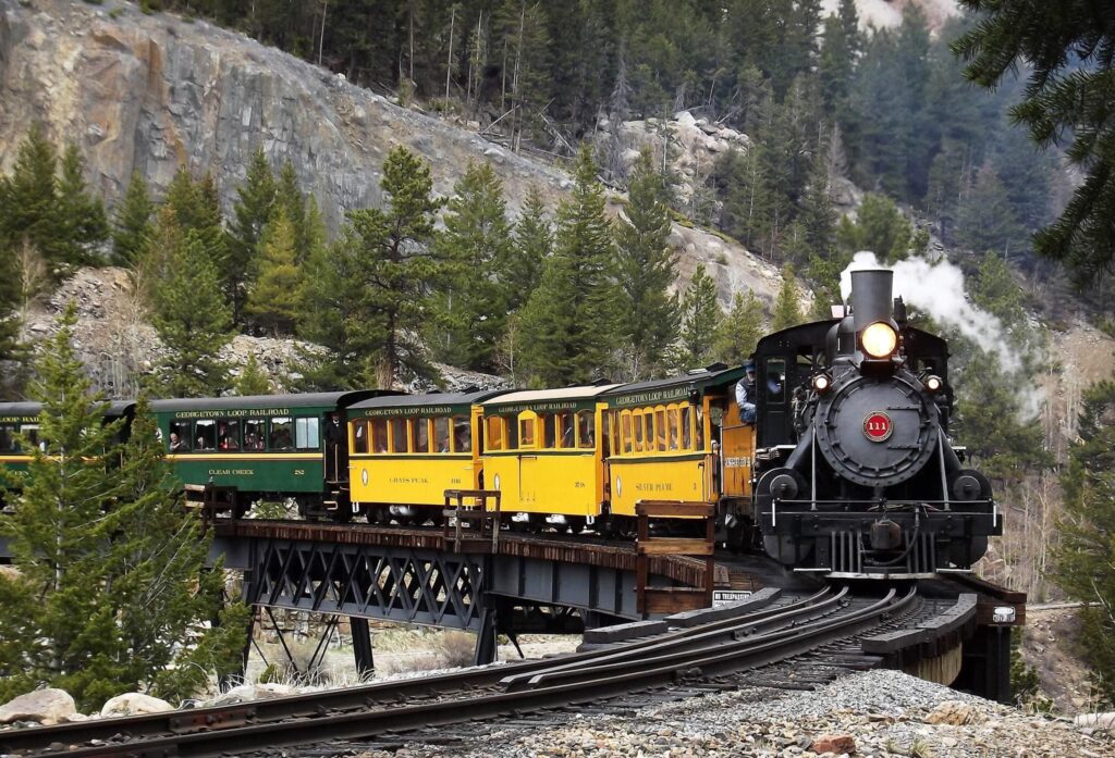The Georgetown Loop Railroad train chugging along on an elevated bridge