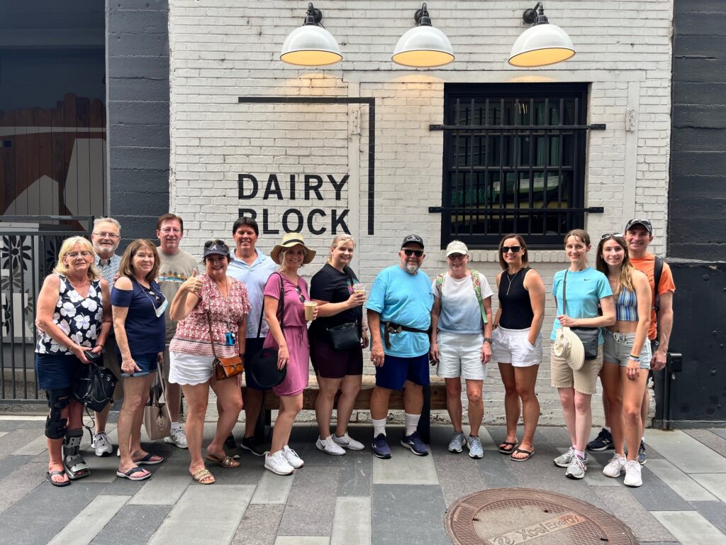 A corporate team posed within Dairy Block on a Big Bite Tour