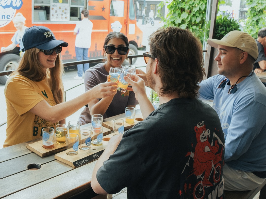A corporate group sharing a toast at Denver Beer Co.