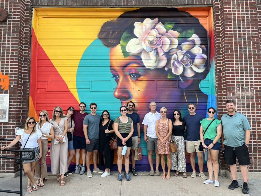 A corporate team on a RiNo Arts District Food Tour, backdropped by a colorful mural