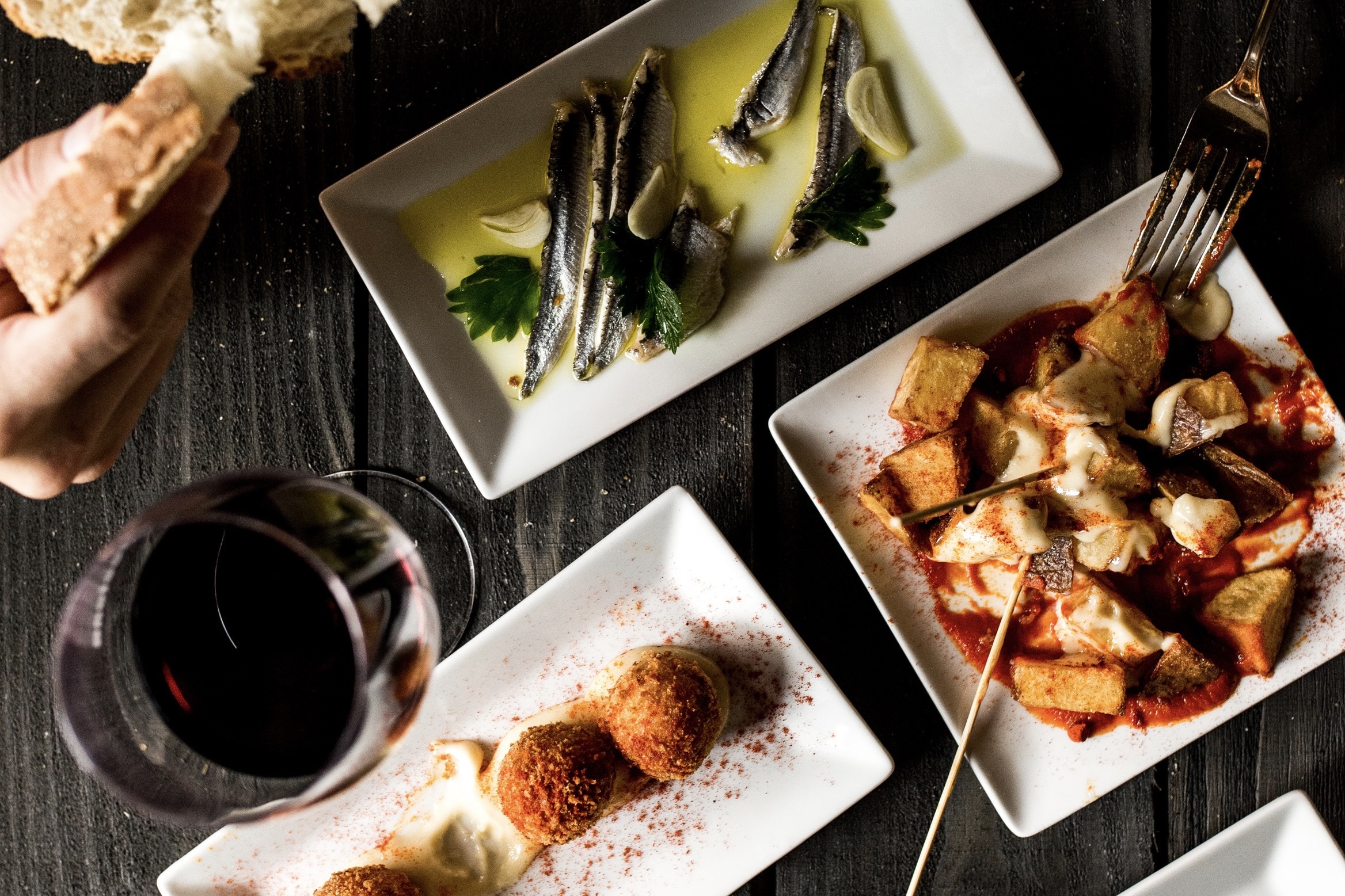 A selection of tapas and a glass of red wine from Barcelona Wine Bar