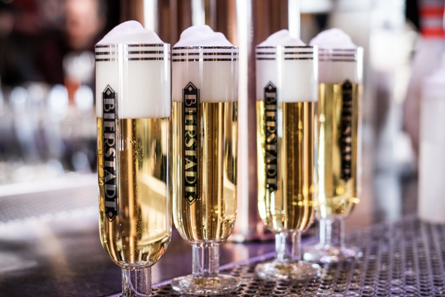 Four slow-pour pils from Bierstadt Lagerhaus, each featuring a foam cap