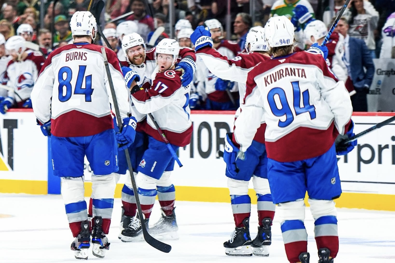 Colorado Avalanche players celebrating on the ice at Ball Arena