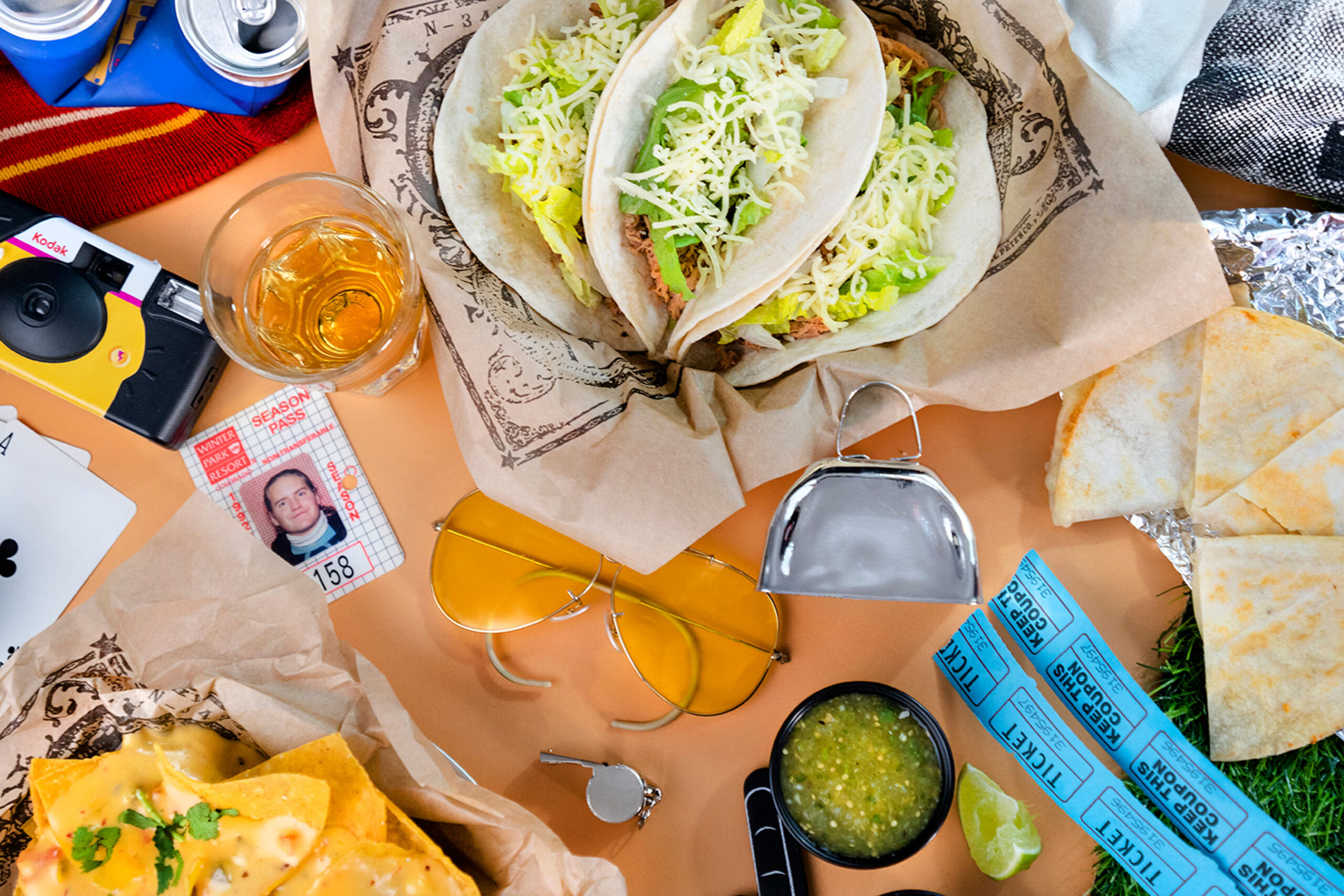 A stylized photo of Illegal Pete's tacos, nachos and quesadilla slices