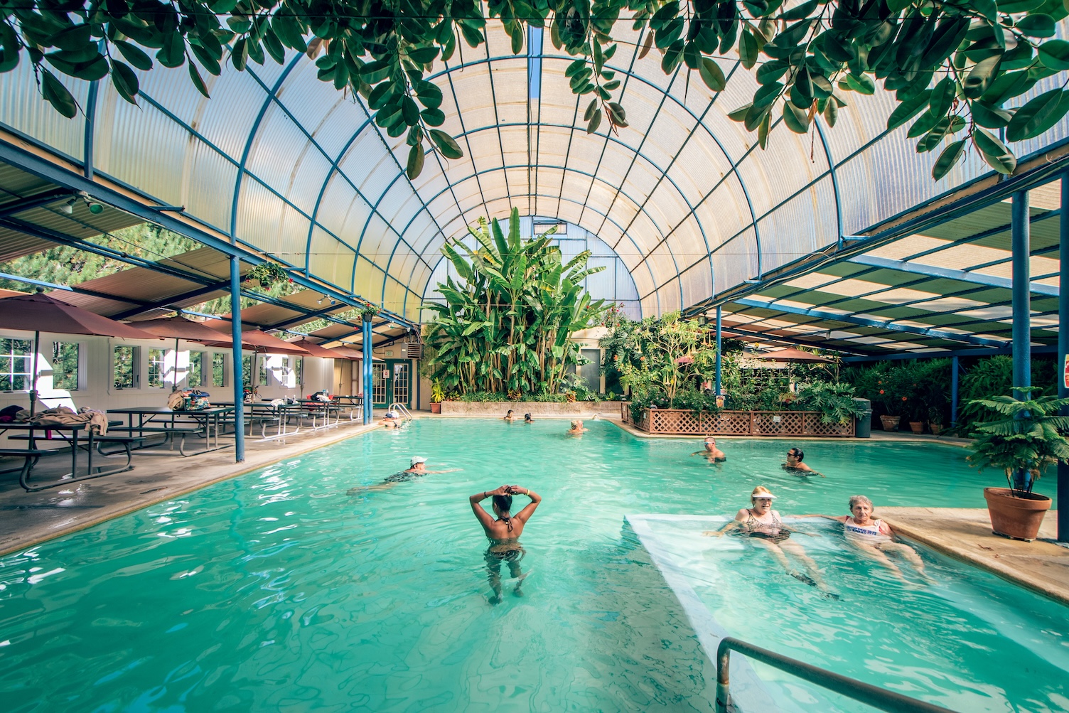 People in the Idaho Hot Springs pool, set beneath a glass dome