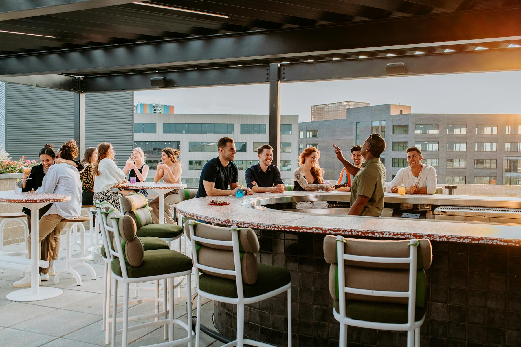 Groups of guests on the Rook rooftop featuring skyscraper views