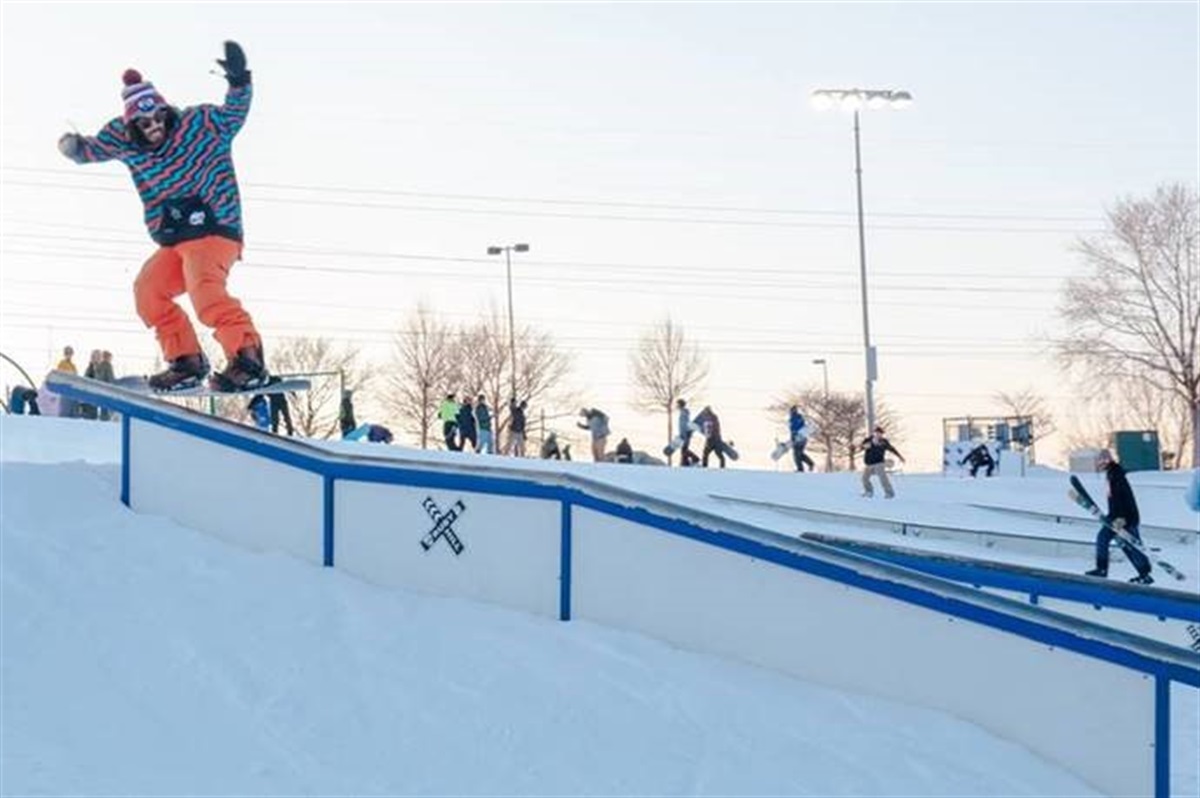 A snowboarder riding a rail at the Ruby Hill Rail Yard