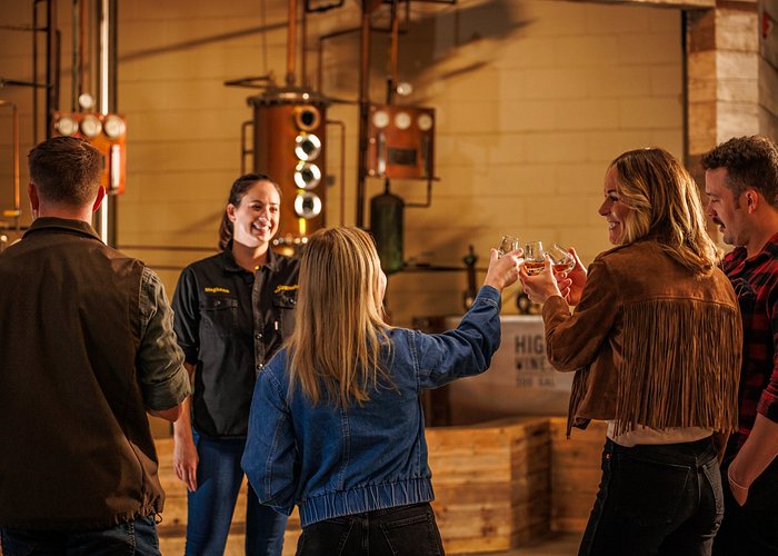people cheersing with whiskey on stranahan's distillery tour