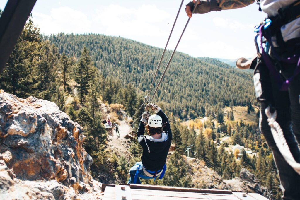 A person ziplining with an AVA guide in Idaho Springs