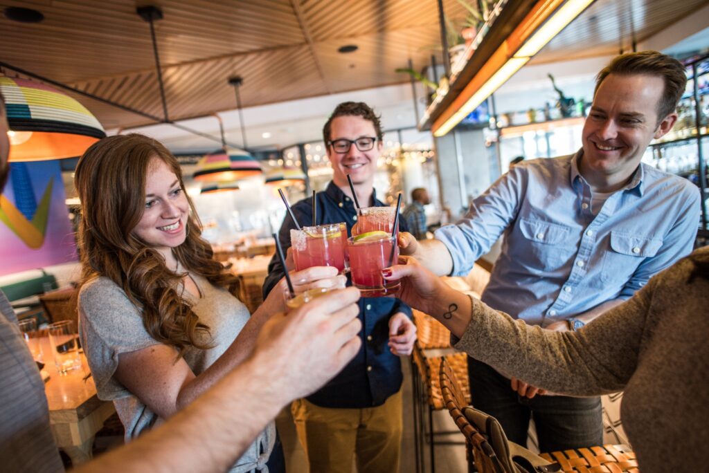 A group toasting margaritas on a Denver Cocktails Tour