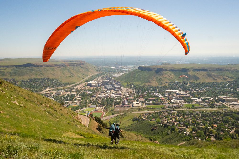 A duo of paragliders taking off in Golden