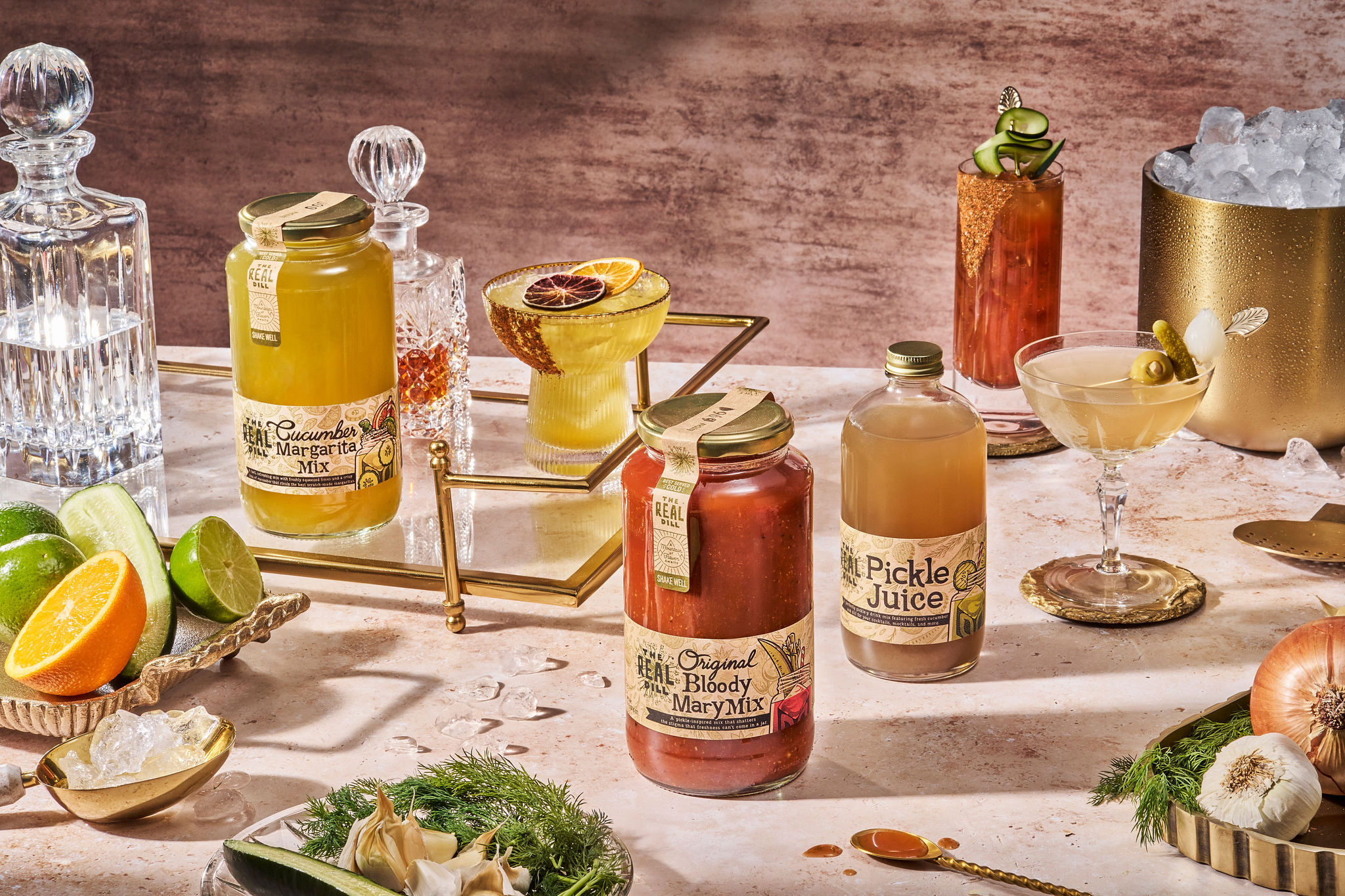Sealed jars from The Real Dill alongside a range of cocktails, including a martini and Bloody Mary