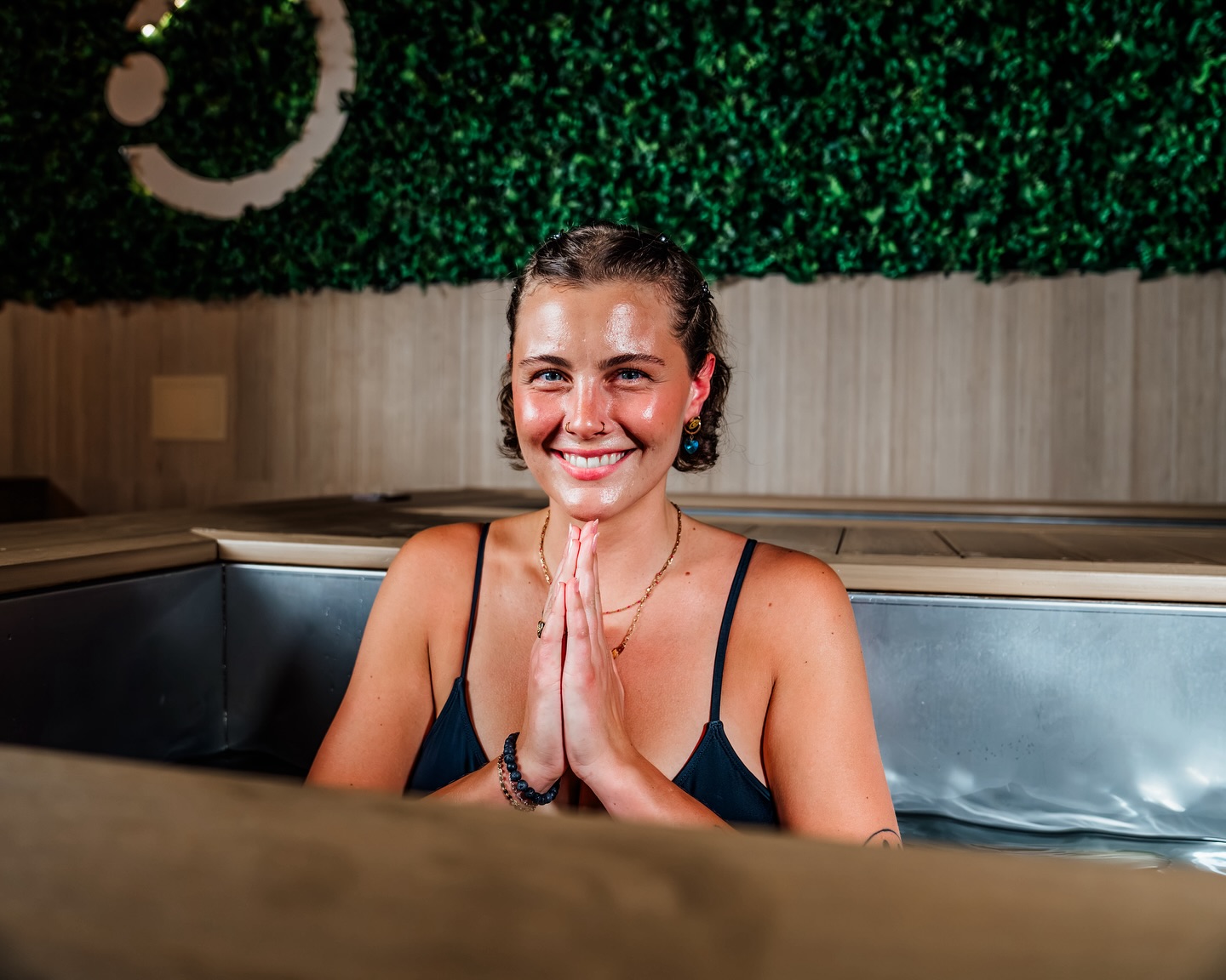 A woman in a cold plunge pool at Reset Mind and Body Belmar 