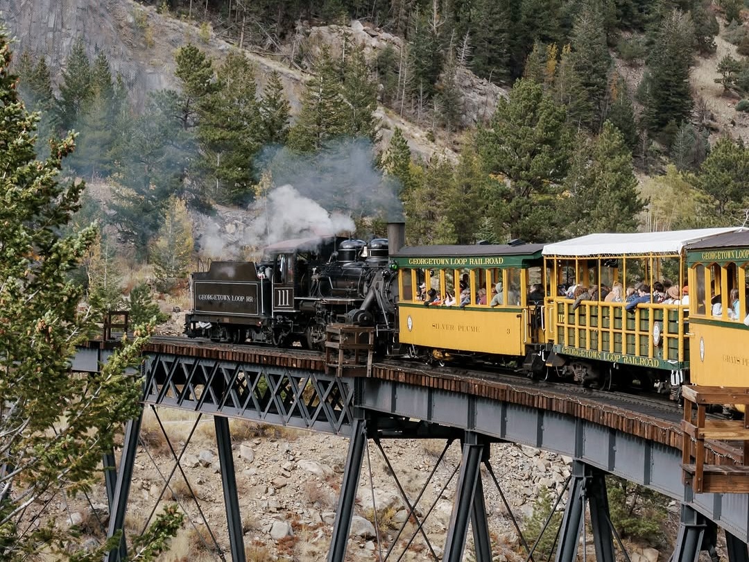 People riding across a bridge on the Georgetown Loop Railroad