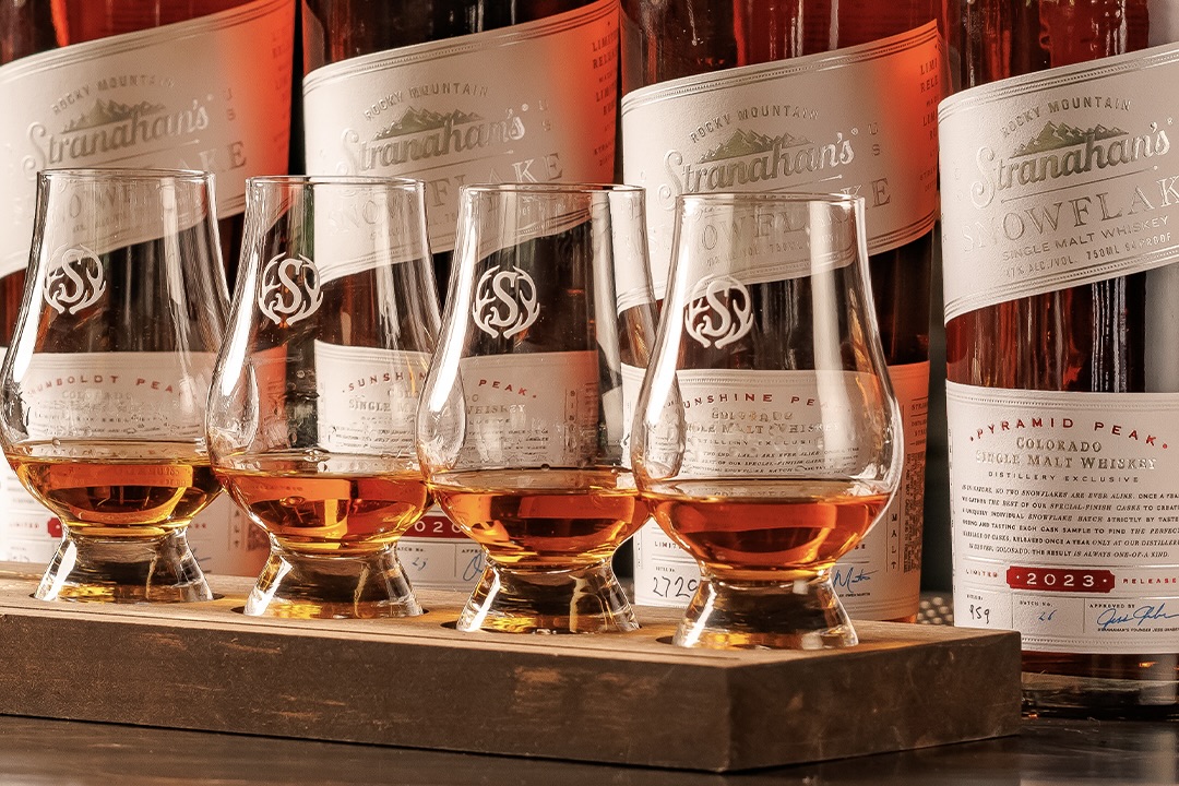 Four tasting glasses full of Stranahan's whiskey