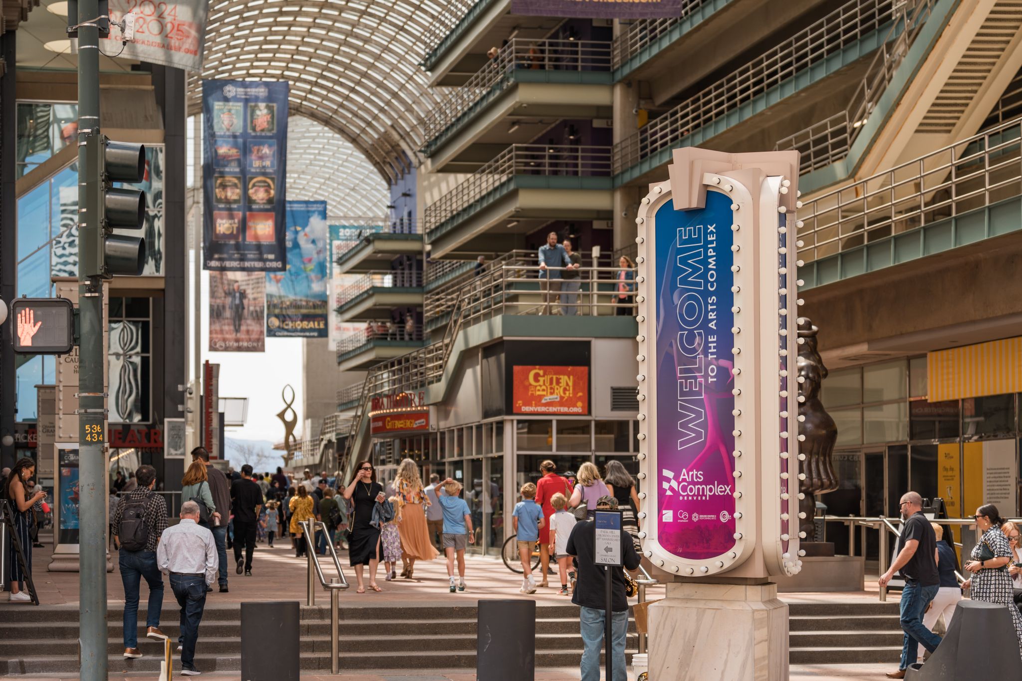 People walking through the multi-level Denver Performing Arts Complex